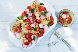 Grilled chicken breast with tomatoes and radishes