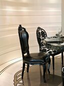 Elegant black chairs at dining table
