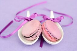 Macaroons on spoons tied with ribbons