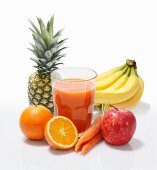 Multi-vitamin juice surrounded by whole fruits