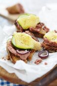 Toasted bread topped with liver pate, cucumber and cheese