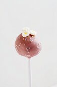 Pink Cake Pop with white sugar pearls and flowers