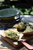 Courgette and leek quiche on a chopping board