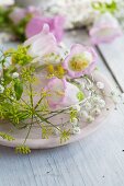 Bell flowers and baby's breath and fennel flowers on a light pink plate