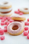 Doughnuts with pink sugar icing and raspberry drops