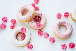 Doughnuts with pink and white sugar icing and raspberry drops