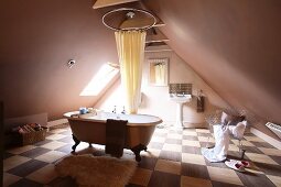 Free standing bathtub in a spacious attic bathroom