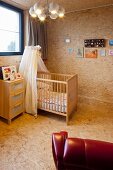 Cot with canopy in nursery clad in chipboard