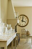 Oversized clock hangs near chimney breast of Provence country house kitchen