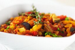 Ratatouille in a White Bowl with a Sprig of Thyme
