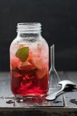 Sangria with crushed ice, lemon and mint in a screw-top jar