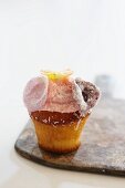 Cupcake with rose petals and grated coconut