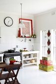 Dark wooden side table; simple sink unit next to cooker in background