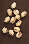 Pistachios on a brown surface