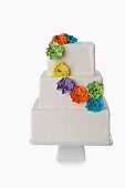 White Tiered Cake with Colorful Floral Decoration; White Background