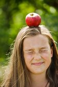 A girl with an apple on her head