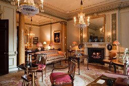 Antique tray table and mahogany chairs, Aubusson rug and Louis XVI chandelier in Georgian salon