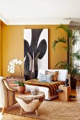 Corner of dark ochre living room with colonial-style lounge chairs