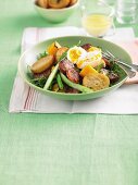 A salad of bread, chorizo, squash, asparagus and a soft-boiled egg