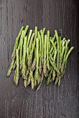 Green asparagus on wooden background