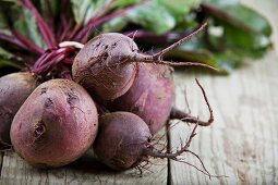 Fresh beetroot on a wooden table (close-up)