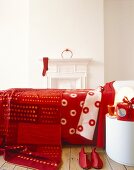 Double bed with red blanket and bed spread