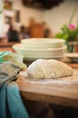 Bread dough on a wooden table in a rustic kitchen