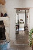 View past masonry fireplace and blue floor vase into Proven