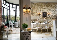 Spacious interior with large bay window, rustic stone wall and elegant furniture