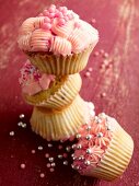 Various cupcakes decorated with pink frosting