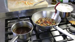 Bolognese sauce being made: red wine being added to the minced meat and vegetable mixture