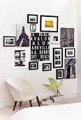 Retro armchair upholstered with white fur fabric below collage of black and white photographs and lettered artworks on wall
