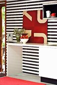 White fitted kitchen with black and white striped wall