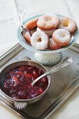 Ausgezogene (Bavarian-style doughnuts) and damson compote on a silver tray