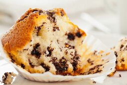 A half-eaten chocolate chip muffin