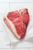 A T-bone steak on parchment paper
