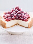 Cheesecake topped with fresh raspberries, sliced