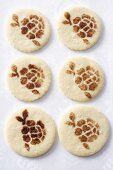 Cookies with patterns stencilled in cinnamon