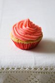 Mini Cupcake with Pink Frosting in a Red Foil Liner Cup