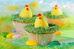 Easter cupcakes decorated with Easter eggs and green sprinkles