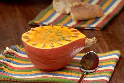 Pumpkin soup served in a hollowed out pumpkin