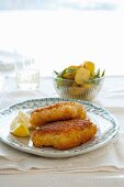 Fish fillet with parmesan crust and a side of potatoes