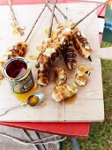 Campfire bread with syrup on a table outdoors