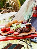 Home-made mini burgers on a camping table outdoors
