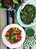 Leaf salad, green lentil salad, green dressing and cherry tomato salad