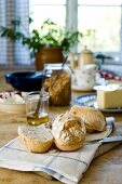 Fresh breakfast rolls on rustic dining table