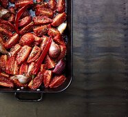 Slow roasted tomatoes with onions and garlic in a roasting dish