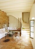 Simple, Mediterranean interior with terracotta tiles and masonry staircase