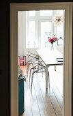 Plexiglass chairs at dining table in renovated period building