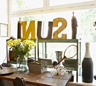 Vintage letters on metal shelves in front of large window